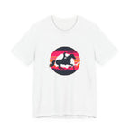 Silhouette of a rider on horseback against a vibrant retro sunset with pink and orange stripes and clouds, circular equestrian graphic art design.