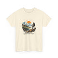 Beige t-shirt with a mountain and person graphic and 'Mental Health > Miles' text on a white background