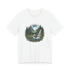 Detailed illustration of a lush mountain landscape with evergreen forest, flowing river, waterfall, and sunlit peaks, featuring the text ‘Seek the Adventure’ in a circular nature-inspired design.
