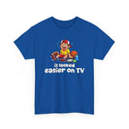 Blue t-shirt with a sports graphic of a cartoon character and text 'it looked easier on TV' on a white background