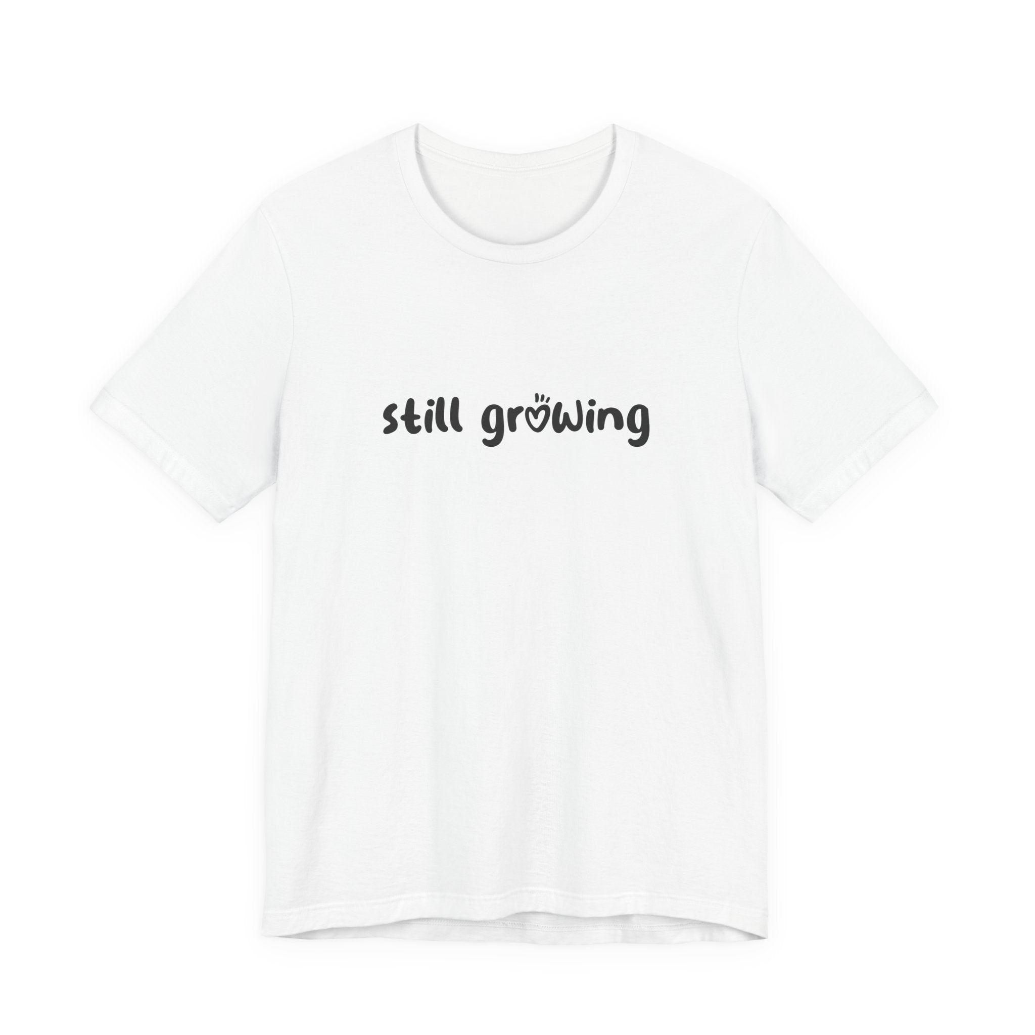 White t-shirt with 'still growing' text on a white background