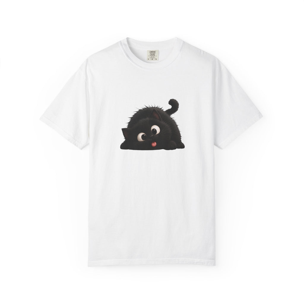 Cute black fluffy cat with big eyes and its tongue sticking out playfully, lying down in a funny pose.