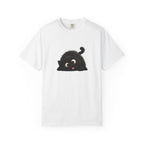 Cute black fluffy cat with big eyes and its tongue sticking out playfully, lying down in a funny pose.