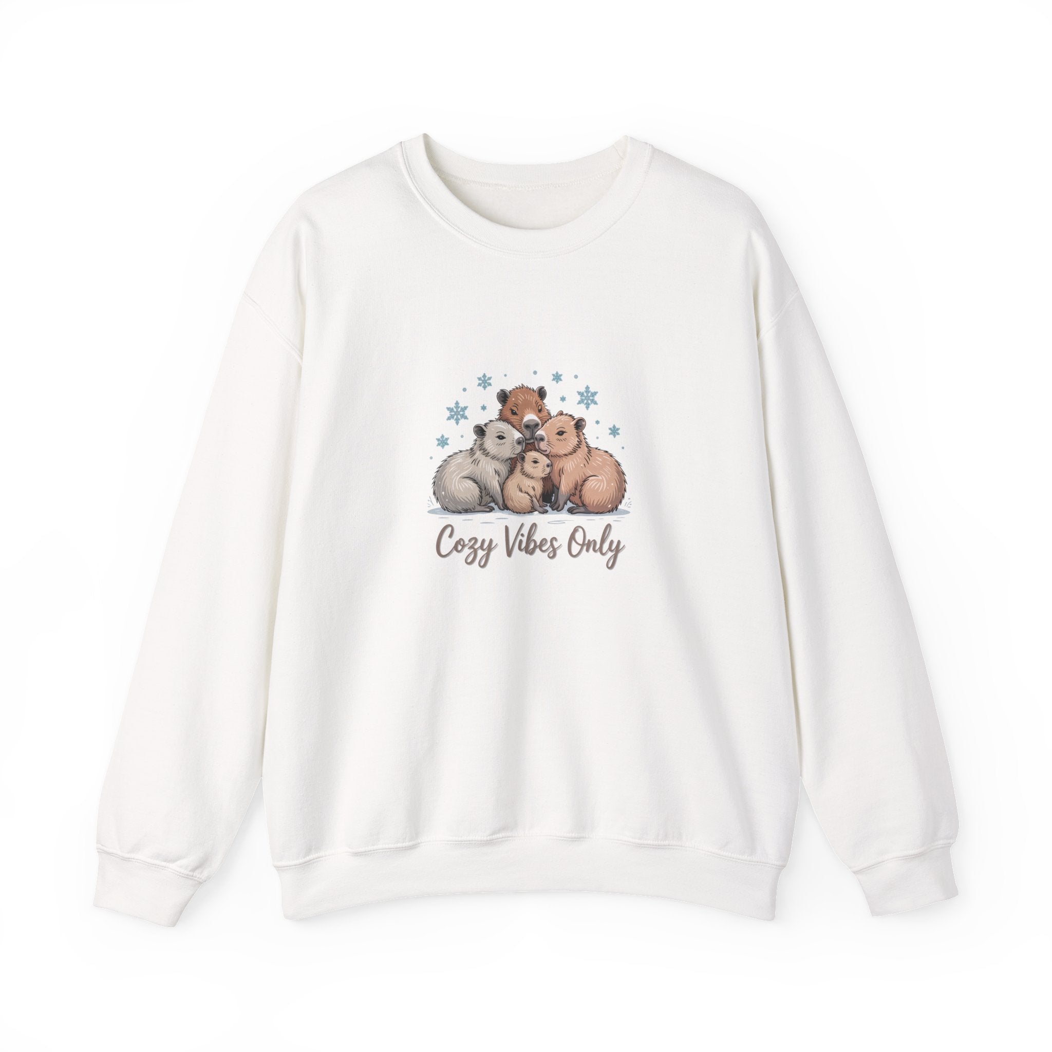 Cute illustrated family of capybaras cuddling together with snowflakes and the text ‘Cozy Vibes Only,’ cozy winter animal art.