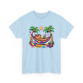 Light blue t-shirt with a colorful graphic of a capybara in a hammock between palm trees on a white background.